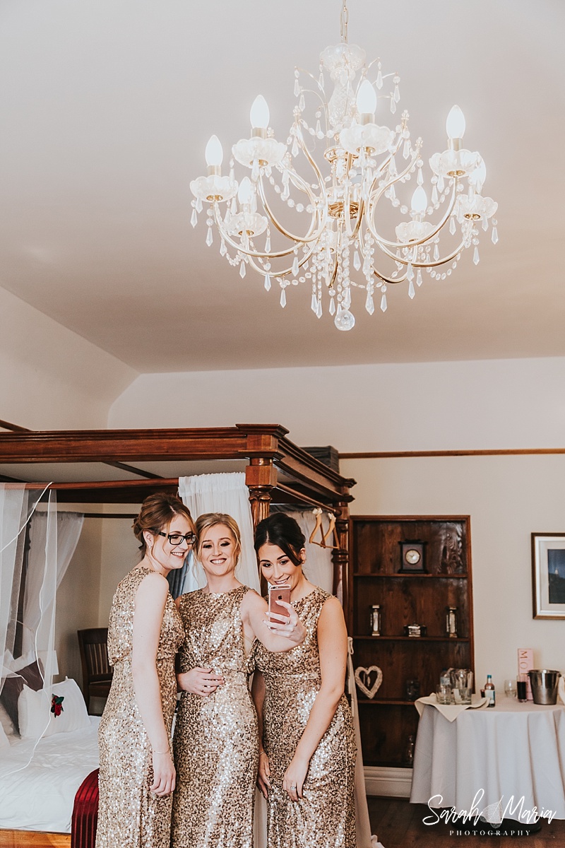 bridesmaids taking a selfie in gold sequin dresses