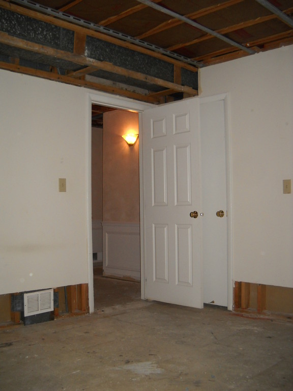 damaged drywall on ceiling and base of wall has been removed