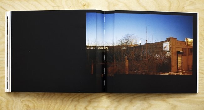 Folded-in double gatefold spread displaying a single photograph of a UFO graffiti painting on a building in Brooklyn.
