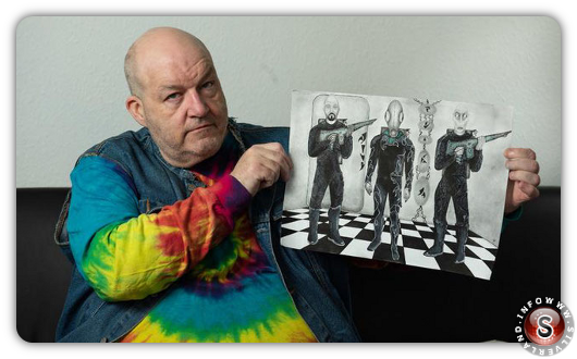 Russ Kellett and his drawings of the aliens. Credit: Mercury Press