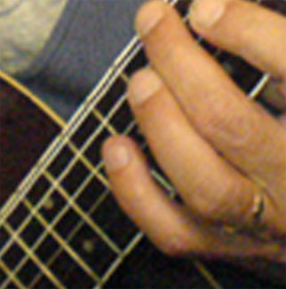 close up of Jamie's hands playing guitar