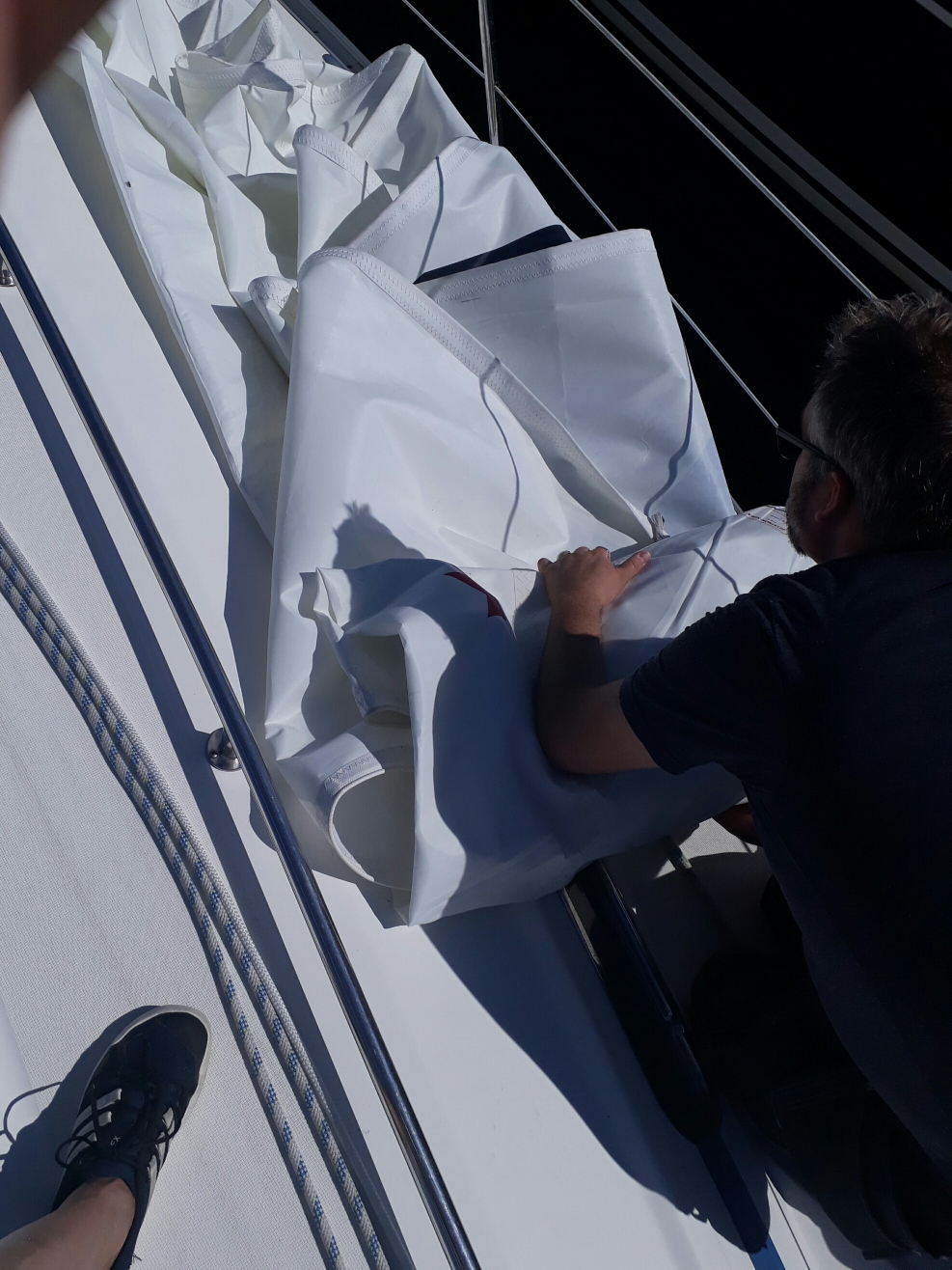 Folding up the sail for repair 