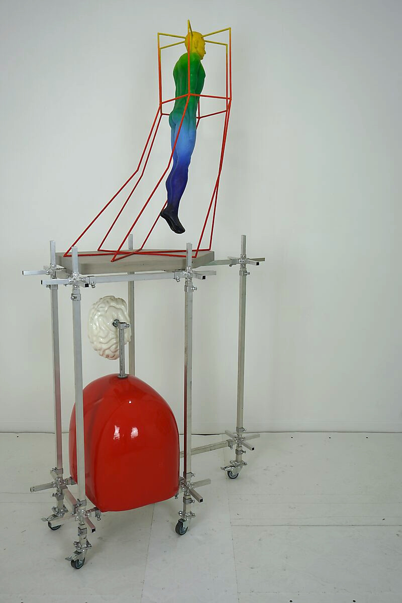Choose and Change — studio setup with a vertical installation, where a figure floats within a colored linear frame above an aluminium structure.