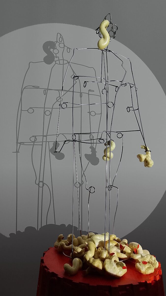 Sfincterman No.0 — videostill: larger forms cling to the head and arms, while the base around the figure becomes increasingly covered.