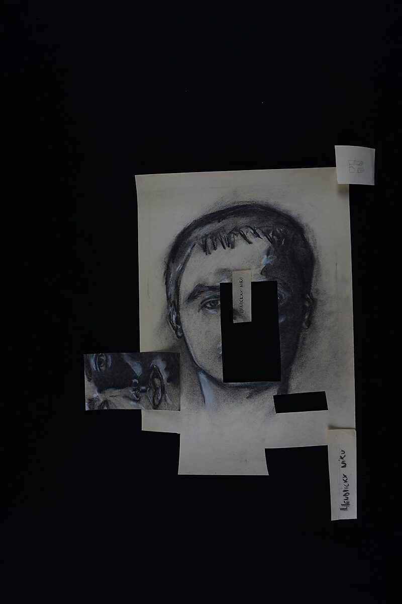 Naming–Value Butterflies — process drawing: self-portrait study 3 PHIKO (1993) — the portrait with several cut-out openings lies on the table with loose name and label strips around it.