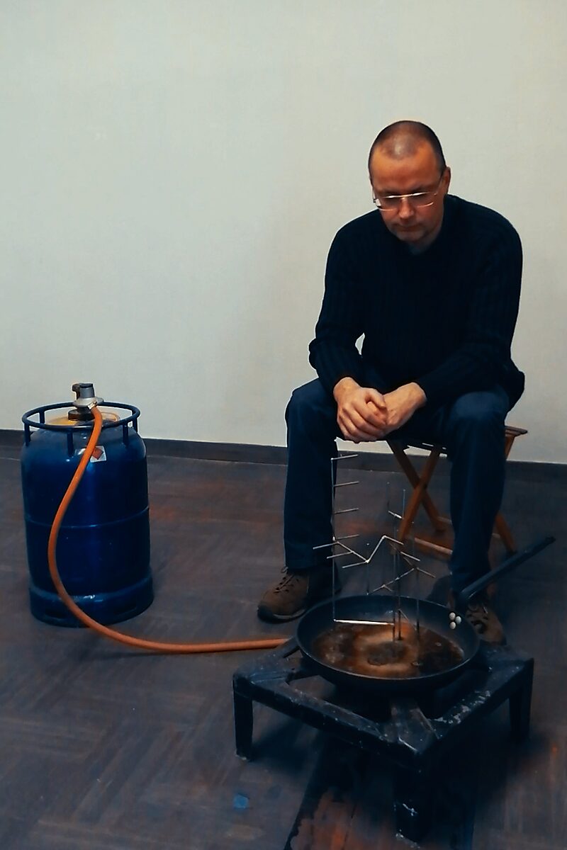 Entropische sculptuur — Aqua Entropica, procesfoto: de kunstenaar test het idee door een metalen sculptuur met ijs boven een gasvuur te plaatsen.