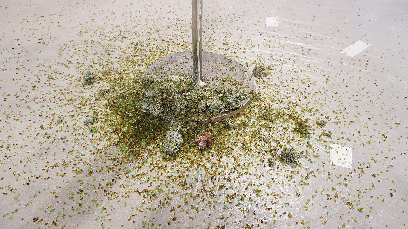 The Great Escape of Saint Sebastian — remnants of melted beef fat and green glass beads accumulate on the floor beneath the installation.