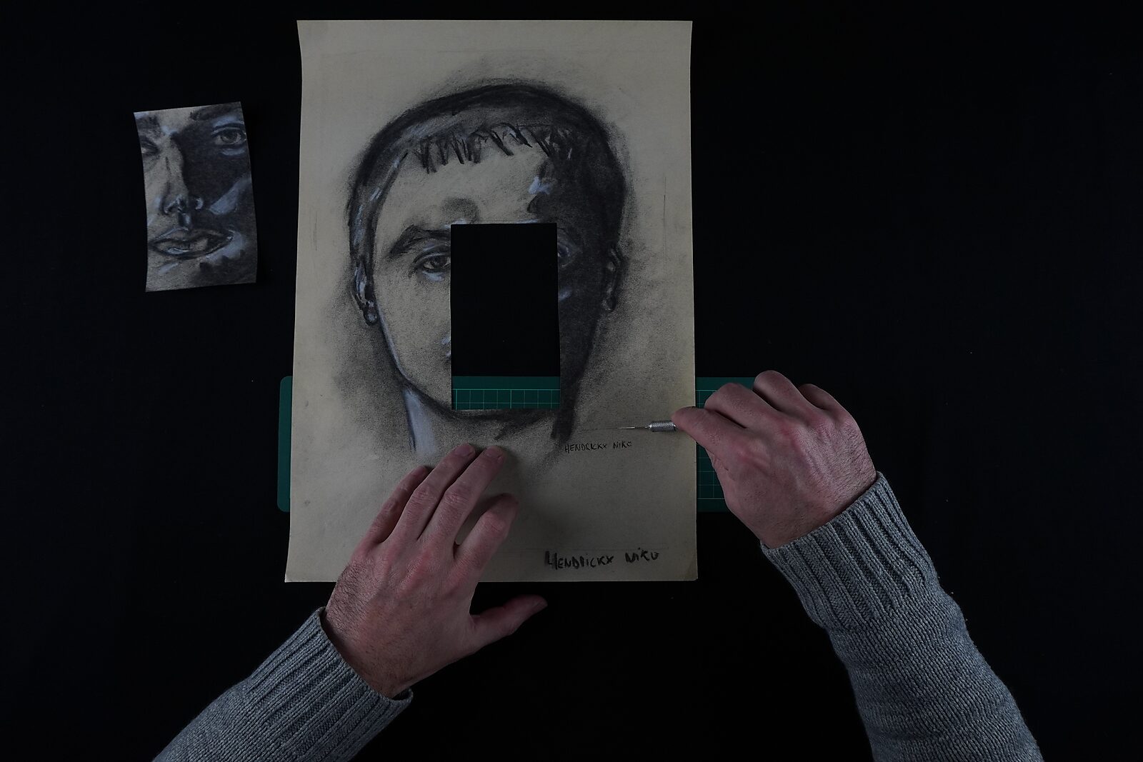 Naming–Value Butterflies — process drawing: self-portrait study 3 PHIKO (1993) — a rectangular piece from the centre of the face has been removed while a fragment of the face lies beside the sheet.