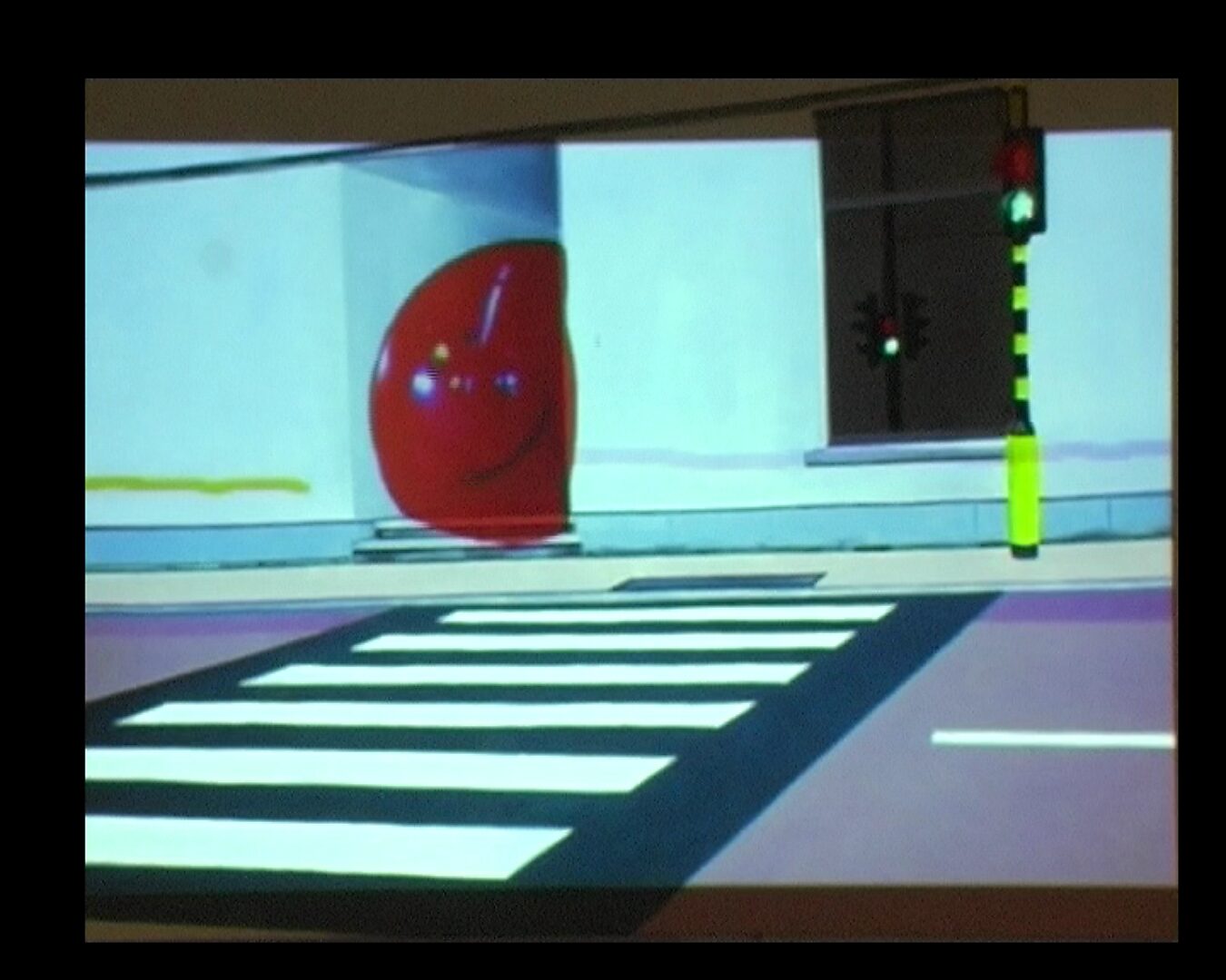 Levend canvas — ‘Blij kloppend hart’ tegen ‘De fluiters’ — videostill waarin het rode hart verder zichtbaar wordt in het straatbeeld terwijl het verkeerslicht en het zebrapad op de voorgrond blijven.