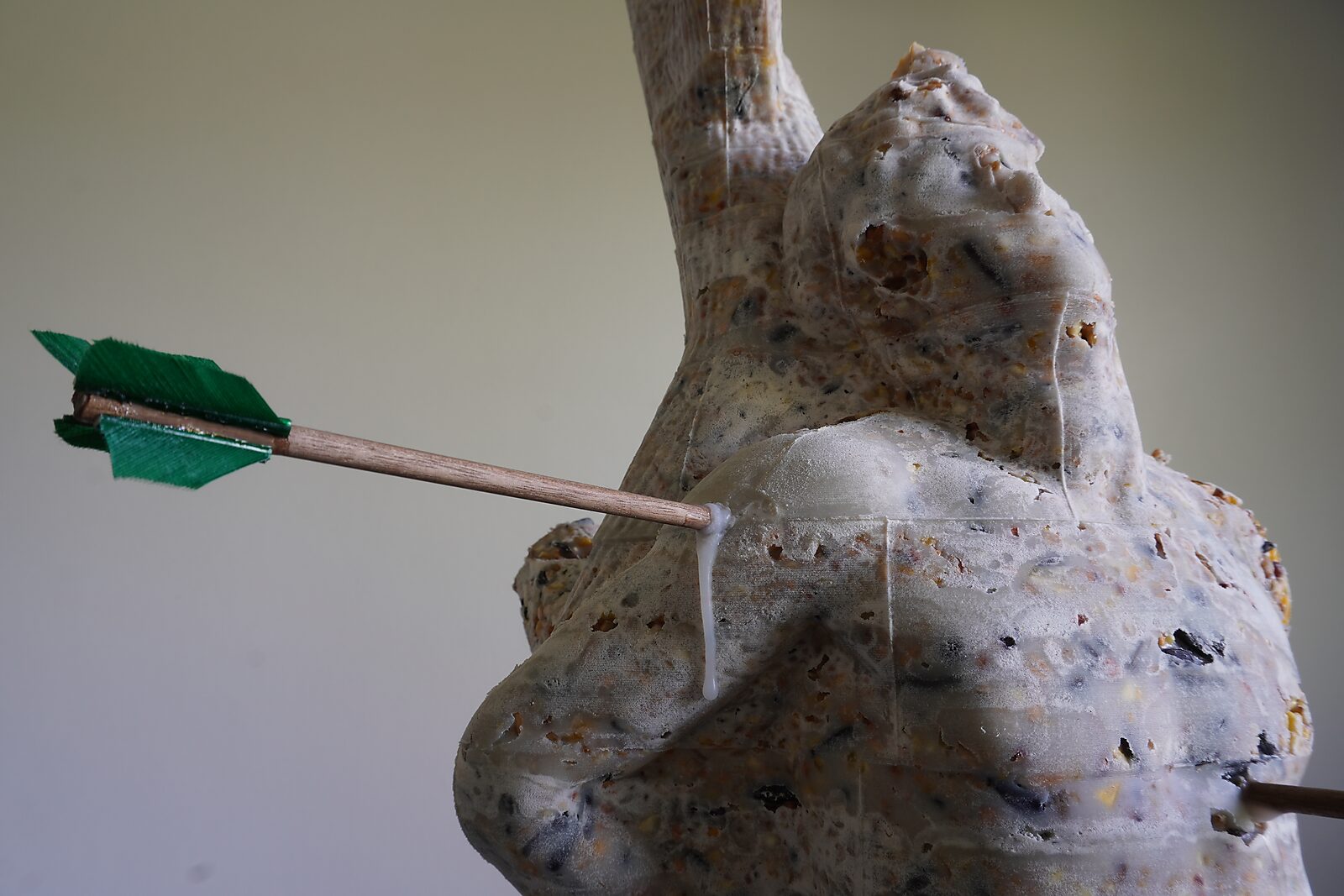 St. Sebastian with Birds No. 2 — detail photo of an arrow passing through the shoulder of the cast, with fat dripping along the surface.