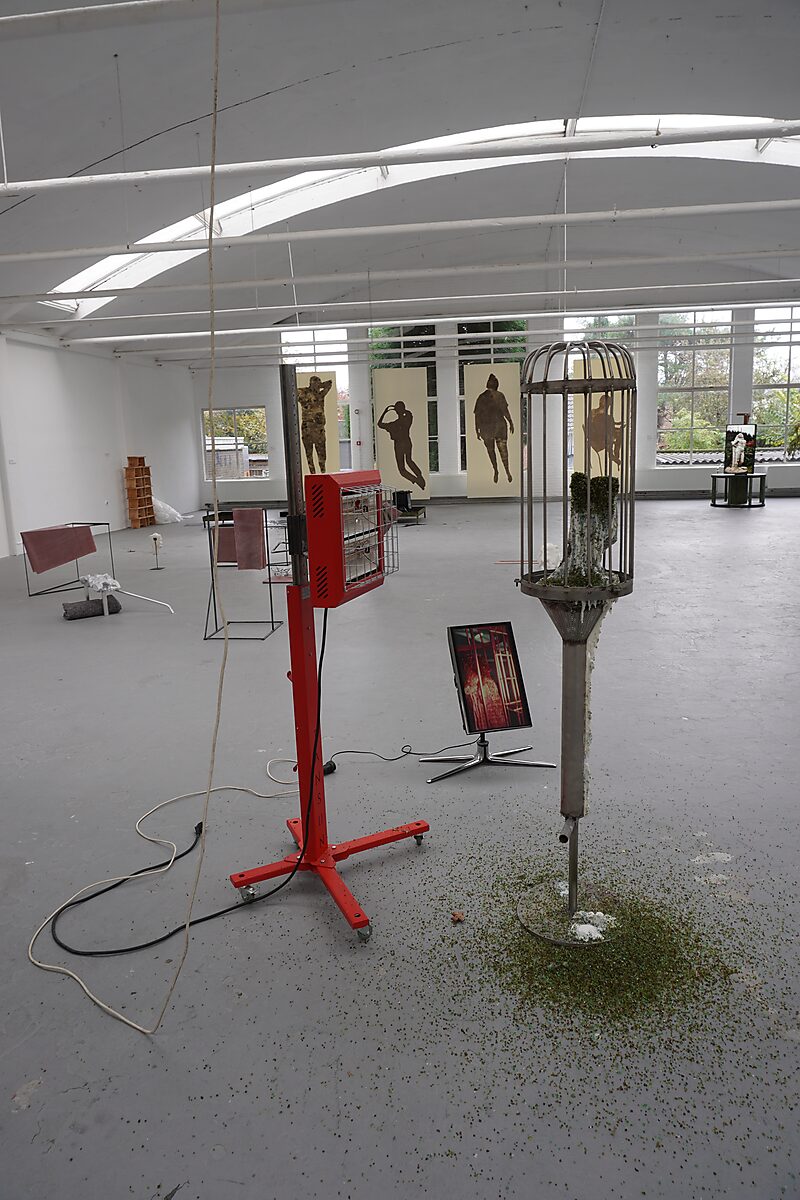 The Great Escape of Saint Sebastian — overview of the installation during the exhibition Malabou in Malibu at De Fabriek in Eindhoven, showing the infrared heater, cage, and melting sculpture.