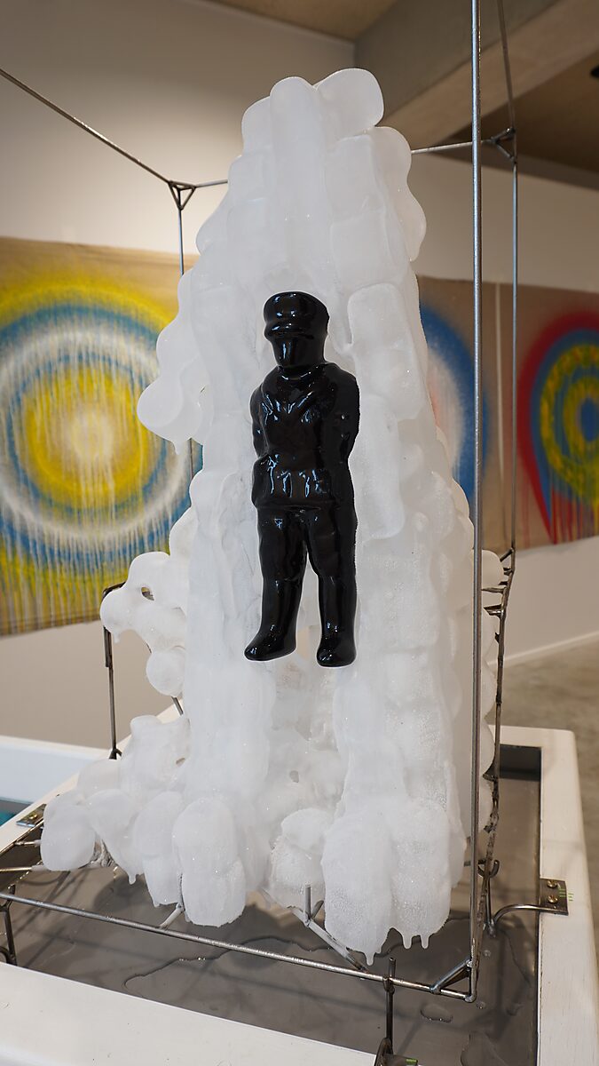 The Bending Monument — process, Transformation Studio No.1: Warm or Cold, CC De Adelberg Lommel: a small black polyester figure used as the mold for the monument in the animation hangs in a metal frame and becomes partially covered by a growing structure 