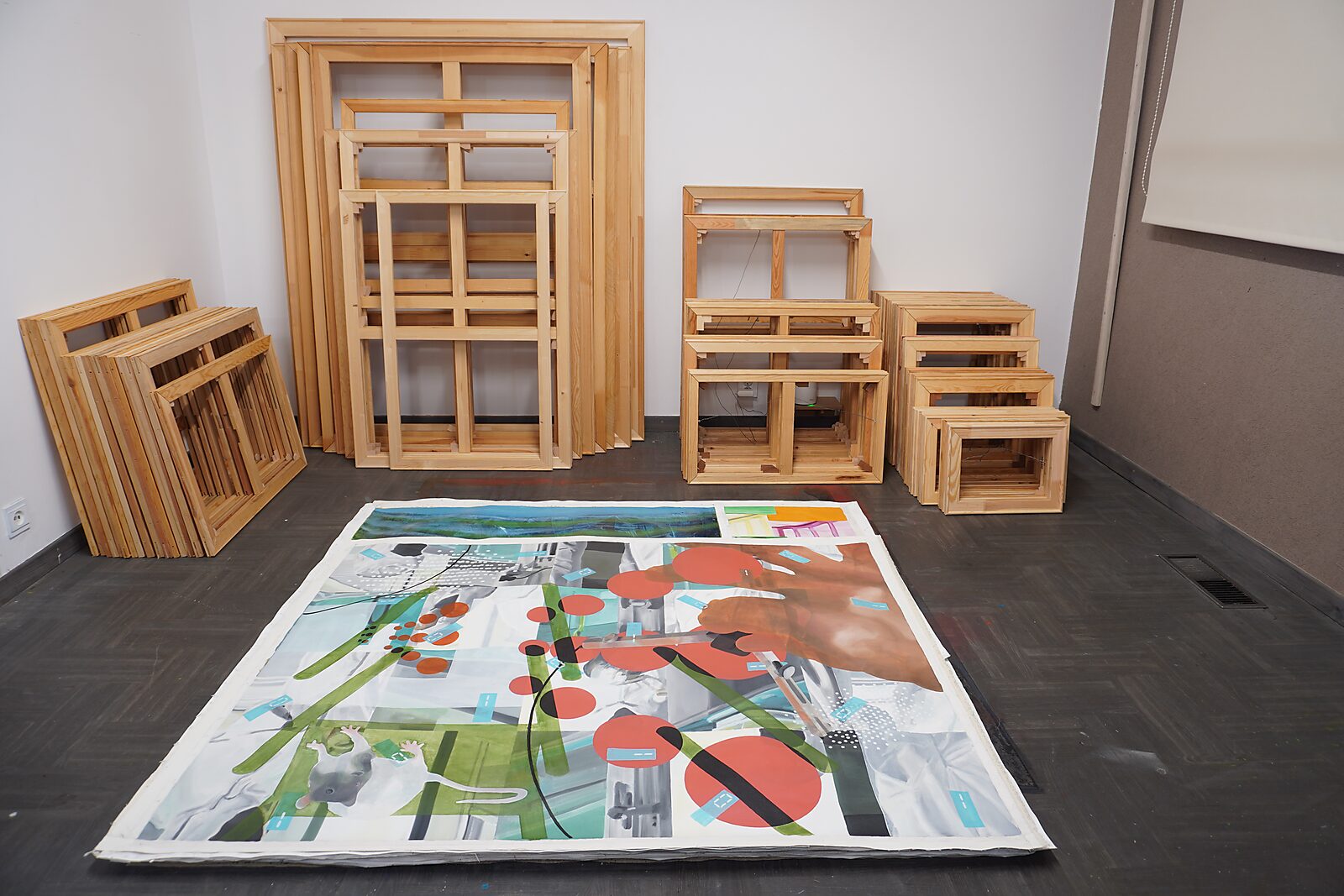 Paintings to Pure Canvas — installation view showing paintings removed from their stretcher frames and stacked as loose canvases, while the empty wooden structures remain in the background as remnants of their original support.