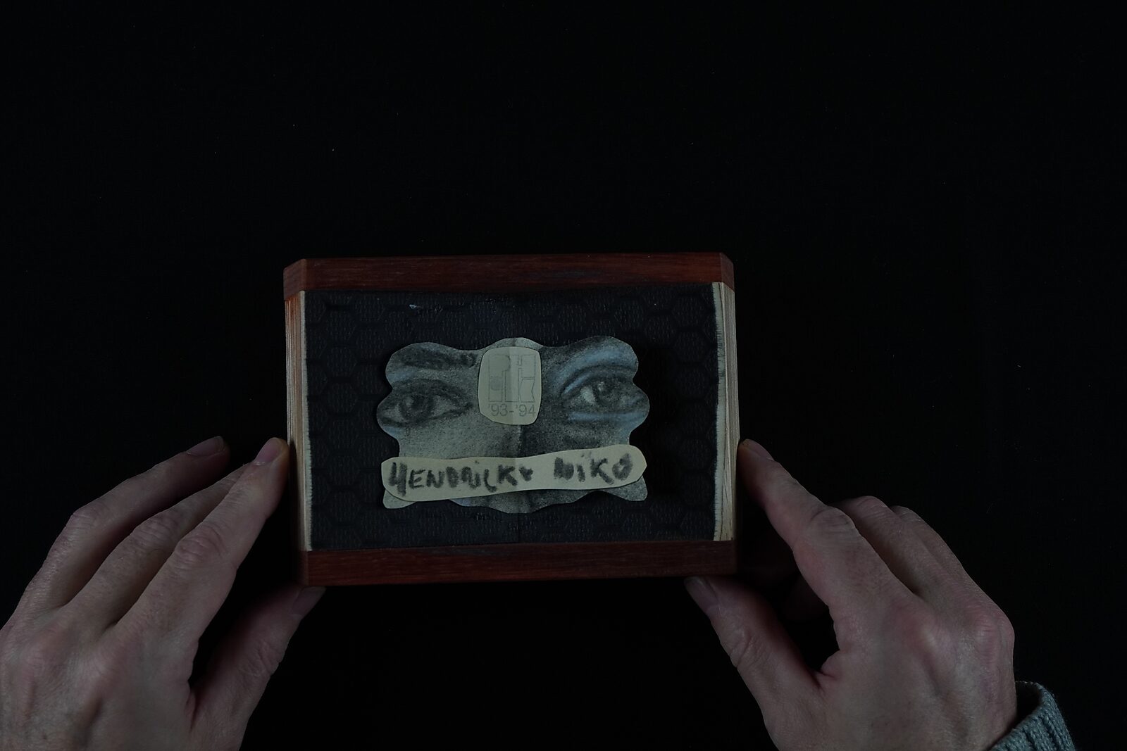 Naming–Value Butterflies — process drawing: self-portrait study 2 PHIKO (1993), Captured (2025) — the finished naming-value butterfly with the eyes fragment and name strip lies inside a small box.