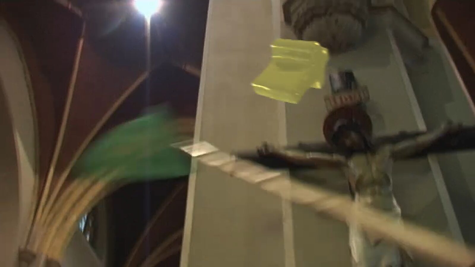 Choose and Change, The Catcher of the Cross — video stills: moving image of a church interior, a golden cross floats and is approached by a green net.