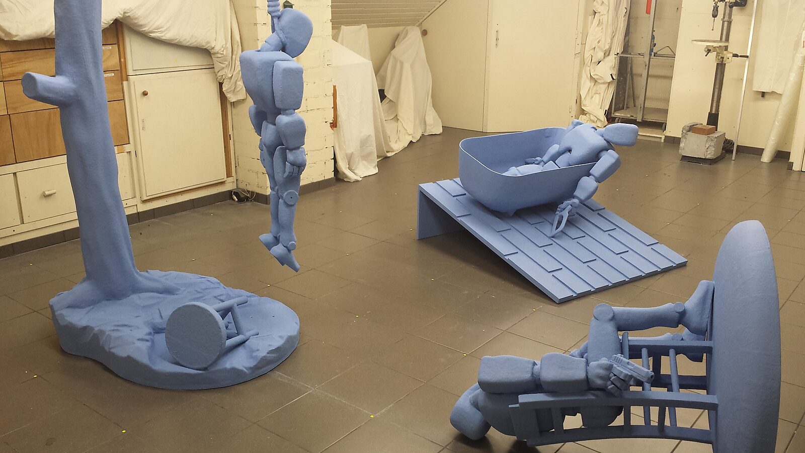 Robot in Denial — reclining robot figure holding an object directed toward its own body, allowing the scene to read as a theatrical yet mechanical confrontation with existence.