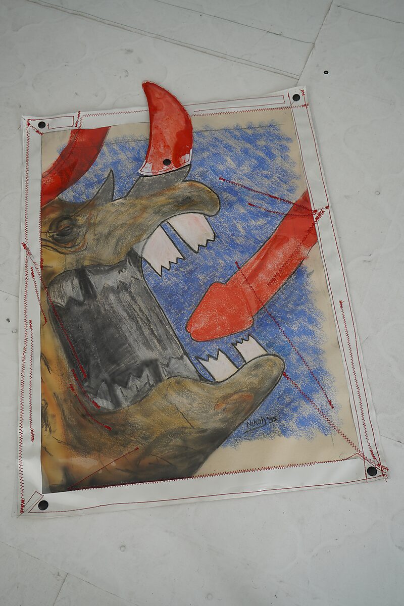 Signature of a Rhinoceros — process photo: rhinoceros head with the red horn reattached to the drawing.