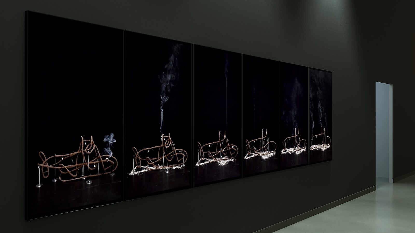 Shipbuilding — perspective view of an installation with six screens along a wall, where the burning process of the sculpture is distributed across the screens as a timeline.