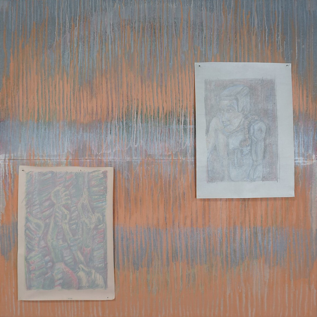 The Divider — process photo: canvas repainted from red and green into skin and metal tones, two modified drawings temporarily placed on the surface.