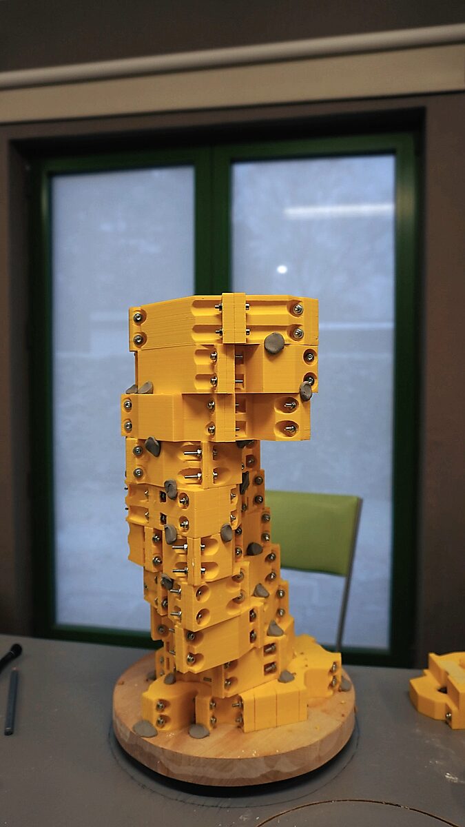 St. Sebastian with Birds No. 2 — video still in which the complete yellow mould encloses the form of the sculpture, built from many screwed segments.