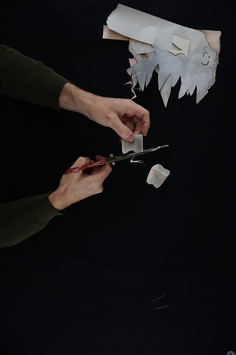 Naming–Value Butterflies — process drawing: Robotman (1995) — a small fragment is trimmed further with scissors, forming a compact shape.