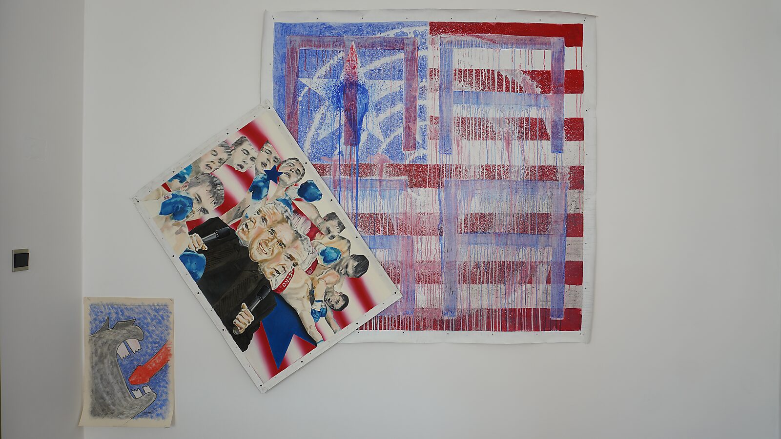 Signature of a Rhinoceros — process photo: composition with other canvases — the drawing Rhino’s Revenge hangs on the left next to other paintings in red, white and blue tones.