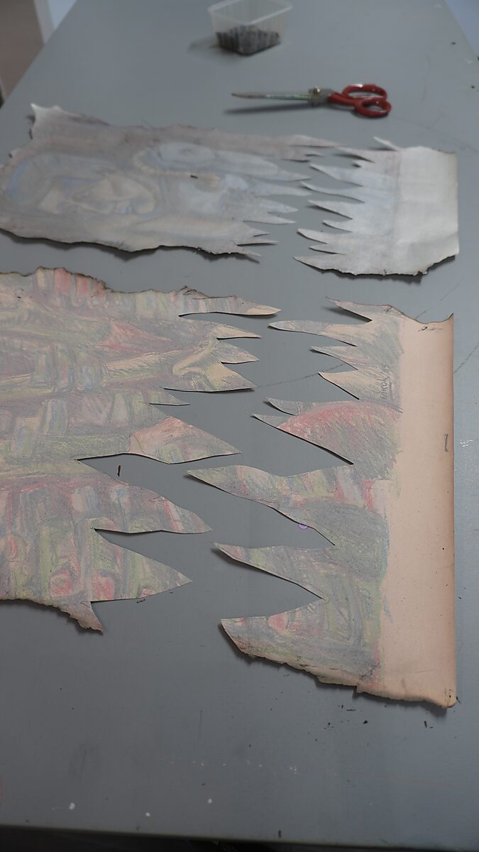 Naming–Value Butterflies — process drawing: Hanging Man (1995) — two pieces of the drawing lie on the table; the edges are cut into sharp tooth-like shapes.