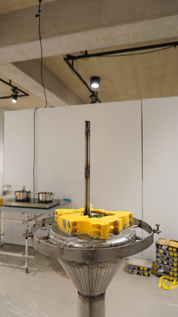 The Great Escape of Saint Sebastian — process photo of the second escape during the exhibition Transformation Studio No.1: Warm or Cold at CC De Adelberg in Lommel; the empty mold is mounted on the installation while pots with melted beef fat are prepared