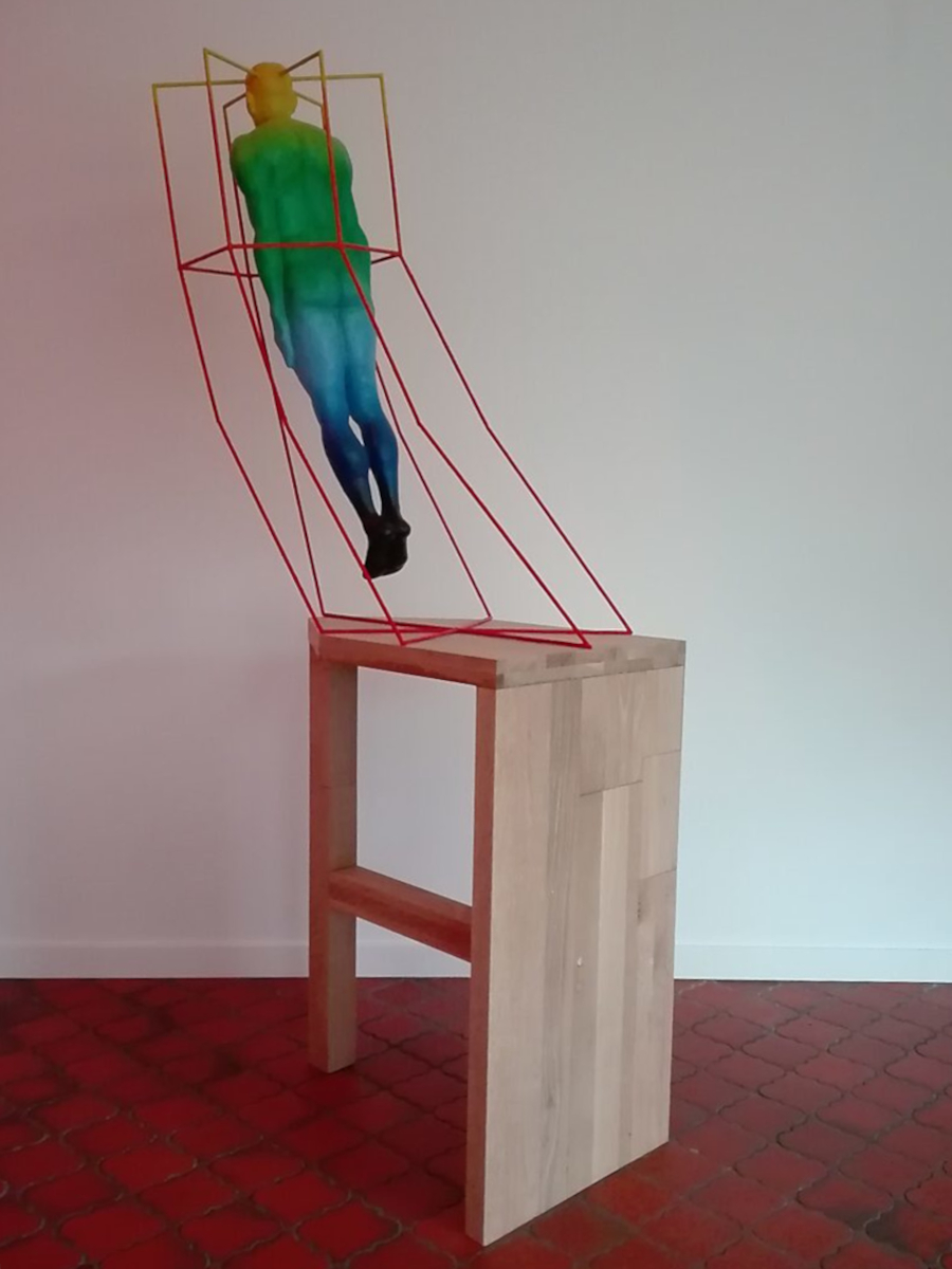 Mindcaging — side view showing the figure leaning forward within the construction, creating tension between movement, control and confined thought.