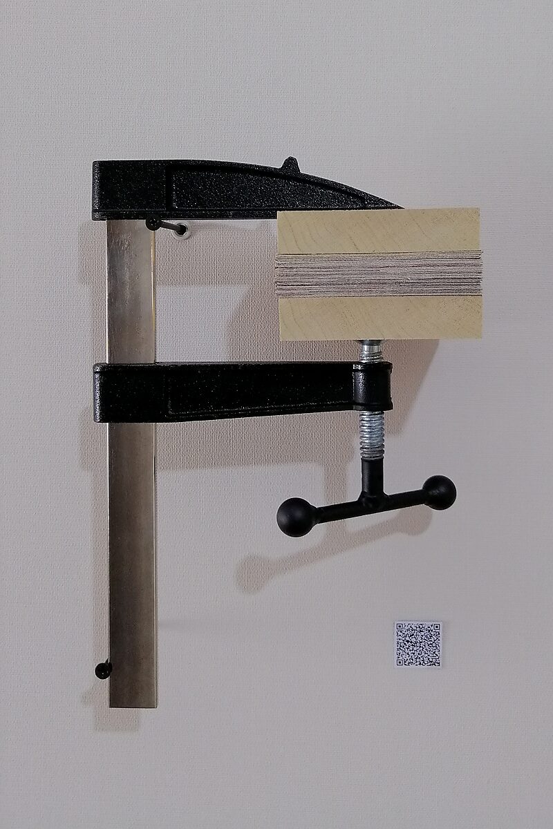 Paintings.zip — again a painting that after being cut is compressed between wooden blocks in a wall-mounted clamp; the pressure of the clamp reduces the painting to a compressed material archive form.