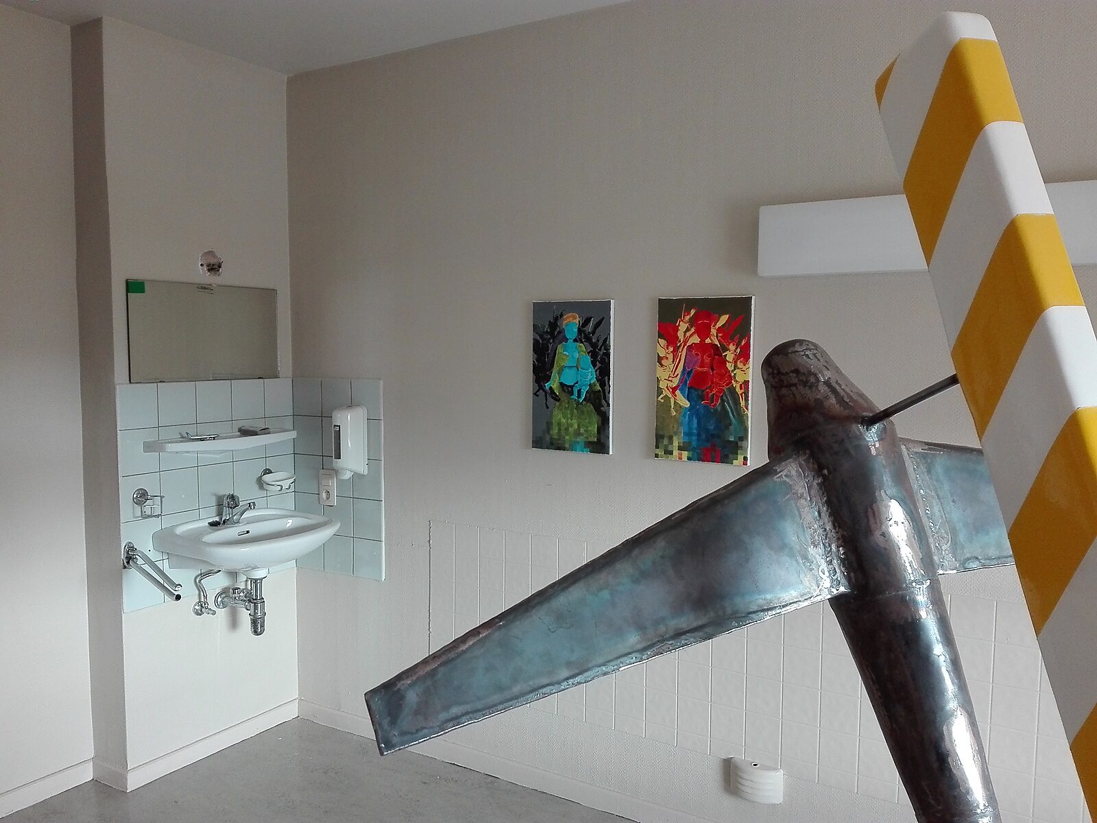 TarmaX: Exhibition view with metal airplane sculpture in a former washroom space with sink and mirror; two colourful figurative paintings on the wall, Tarmac, Meerhout, 2017