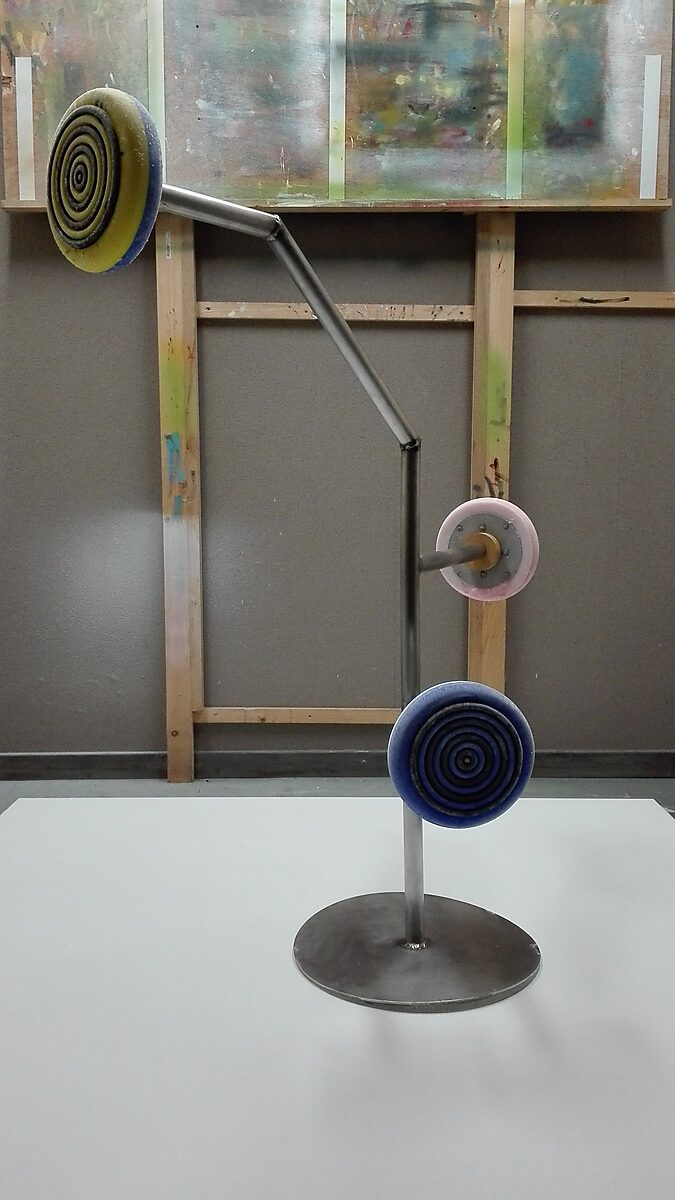 Melting Targets No. 2 — setup with a metal stand holding three frozen ice targets with concentric rings above a white canvas.