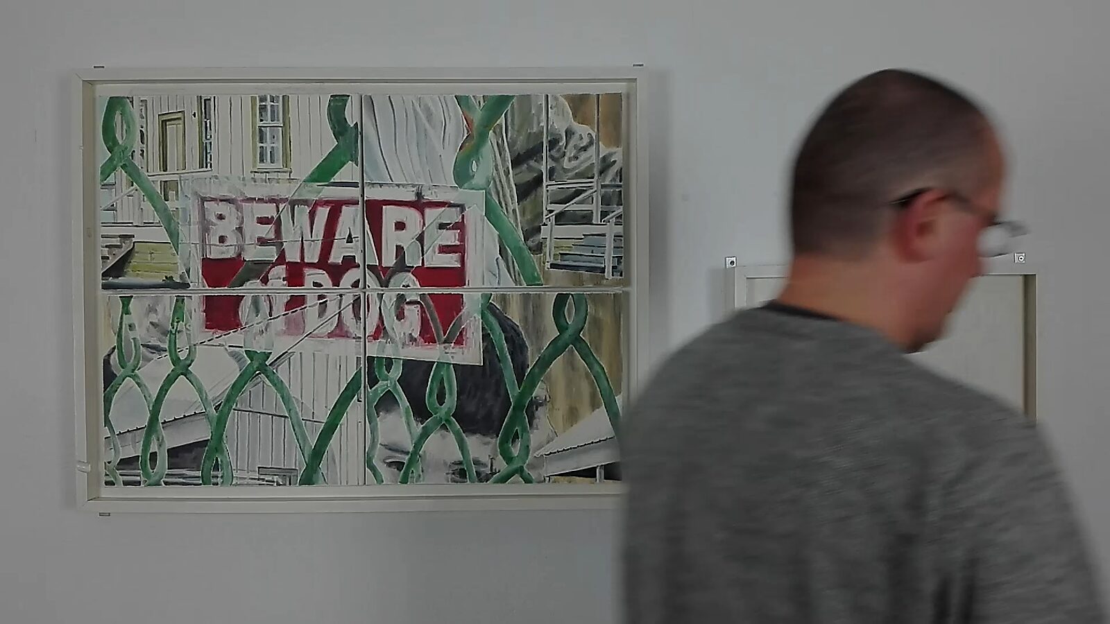 Beware of Dog — action videostill: the man moves in front of the work as the word “BEWARE” becomes clearer within the rearranged composition.
