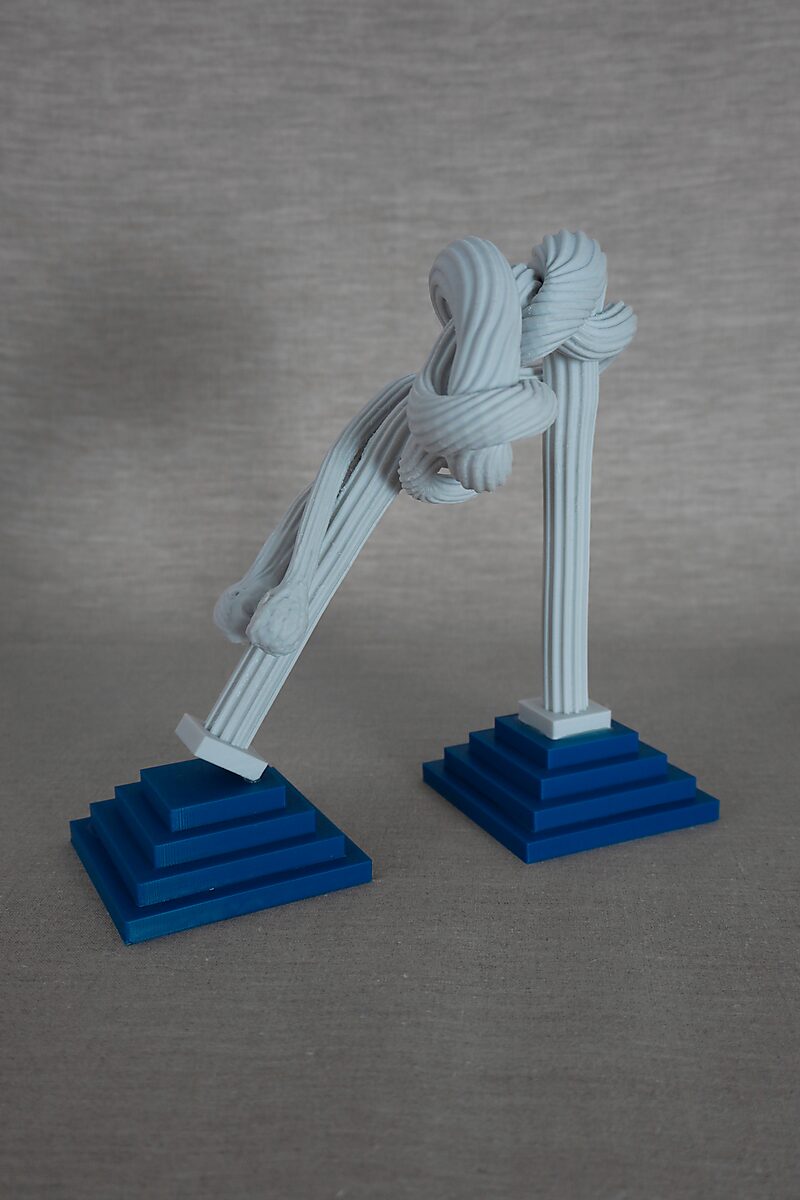 The Columns of Ovidius — Cadmus — side view of two columns, one leaning diagonally, connected by a twisted snake-like structure.