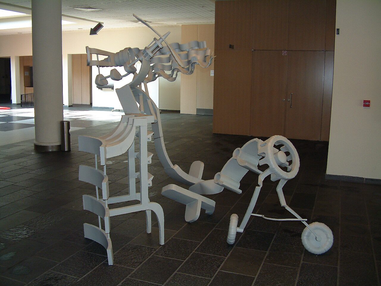 Abstraction of an Airplane — early white version of the sculpture presented at CC De Adelberg, with separated components emphasizing a dismantled and abstracted airplane form.