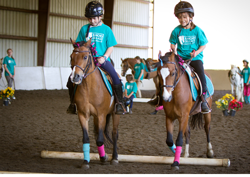 Campers showing off what they learned our Friday afternoon horse show for family and friends