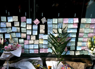 many messages and flowers on the apple store's wall