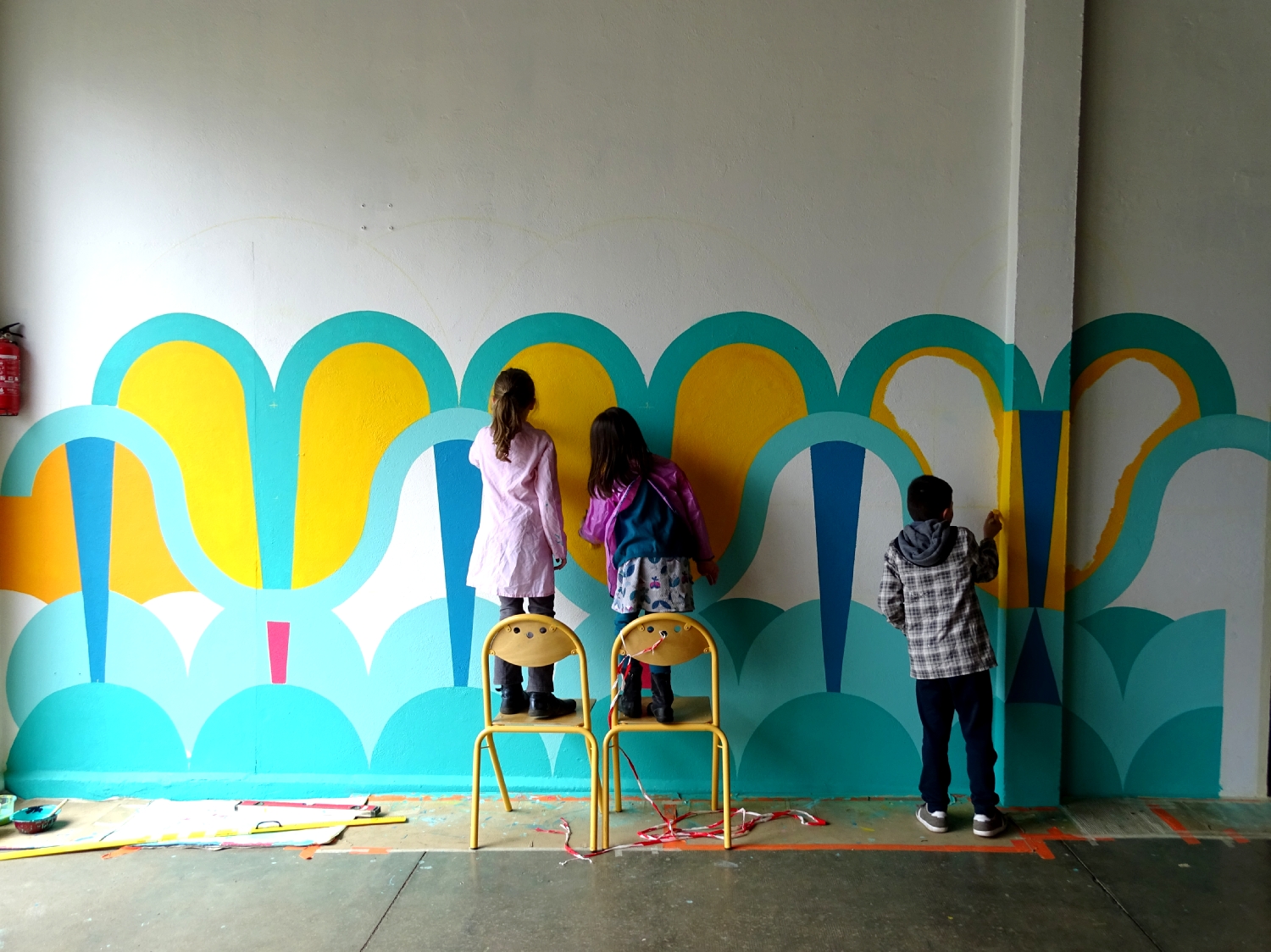 Réalisation de la peinture murale sous le préau de l'école du Moulin à Saint-Uniac. Photo : Marine Bouilloud