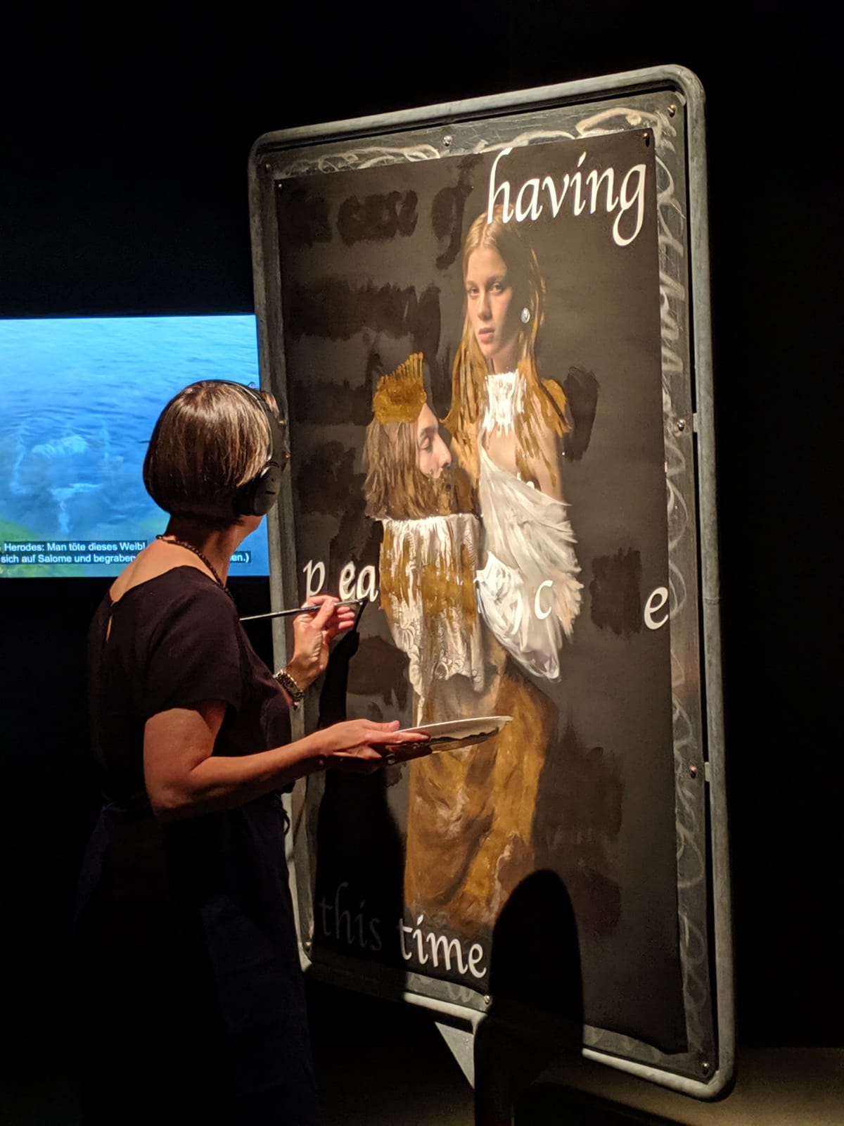 Marianne Iten Thürig "destroying" the poster Salome II of the artist Denys Shantar.