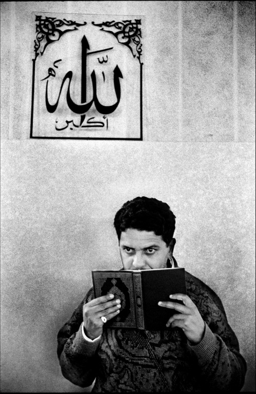 Haidi from Morocco, an invalid homeless who is hosted in Al Huda with the father, kisses the Koran in the mosque.