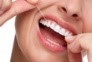 158548500 - woman smile with tooth floss © Kurhan 