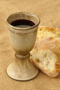 The bread and the wine: SYMBOLS representing Christ body and blood.