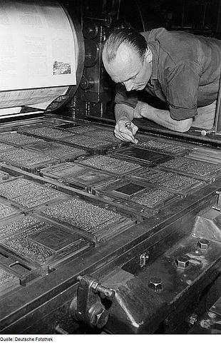 A classic image of a printer inspecting the set and ‘locked up’ pages (or ‘the forme’)