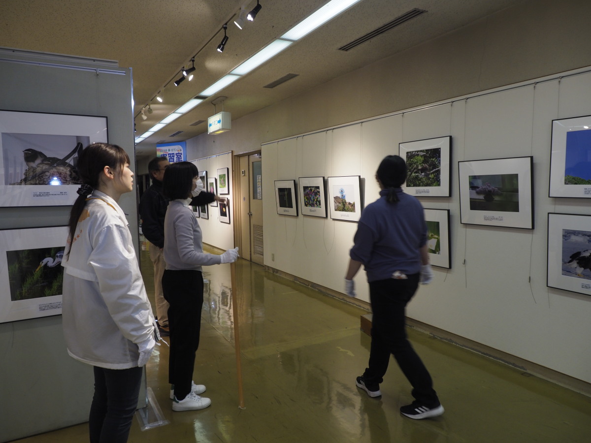 展示中の写真と、展示準備中の館の方々です。ご苦労さまでございます。