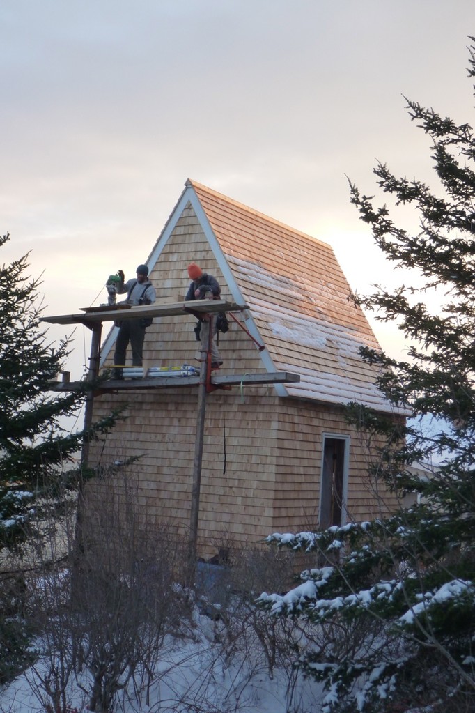 Mark and Rusty cut the last few shingles on the chilly north side