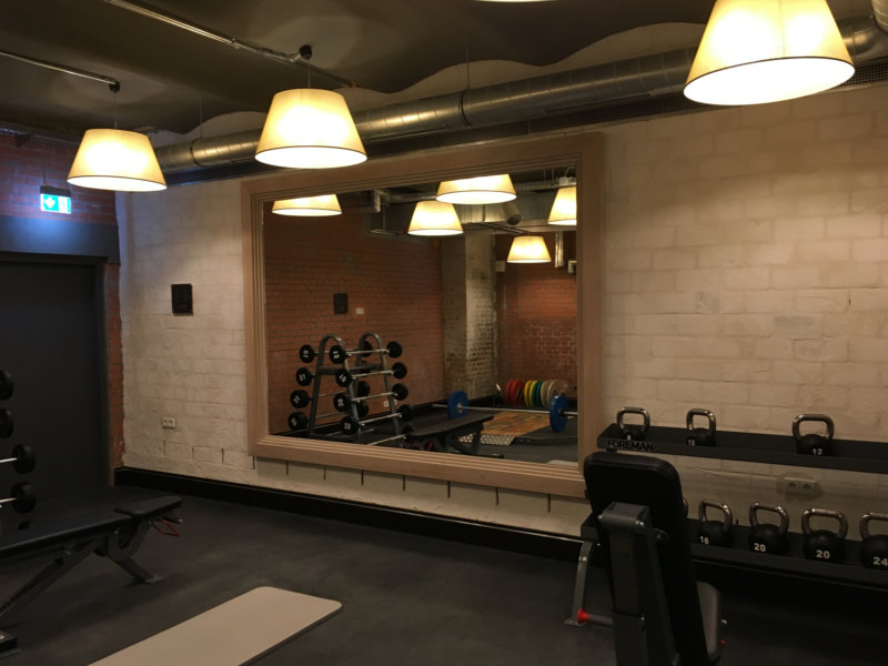 Große Spiegelwand mit Holzrahmen im Fitnessraum