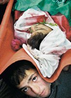Jibril Abdul-Fattah Ibrahim al-Kaseeh 16, jan 4 2005. Mohammed Kaseeh carries the body of his brother killed in clashes with Israeli troops