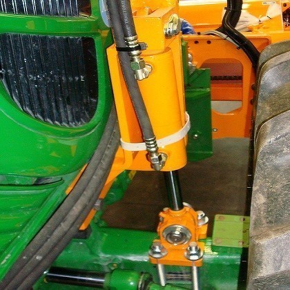 Axle support for tractors, which are equipped with front mowing outriggers