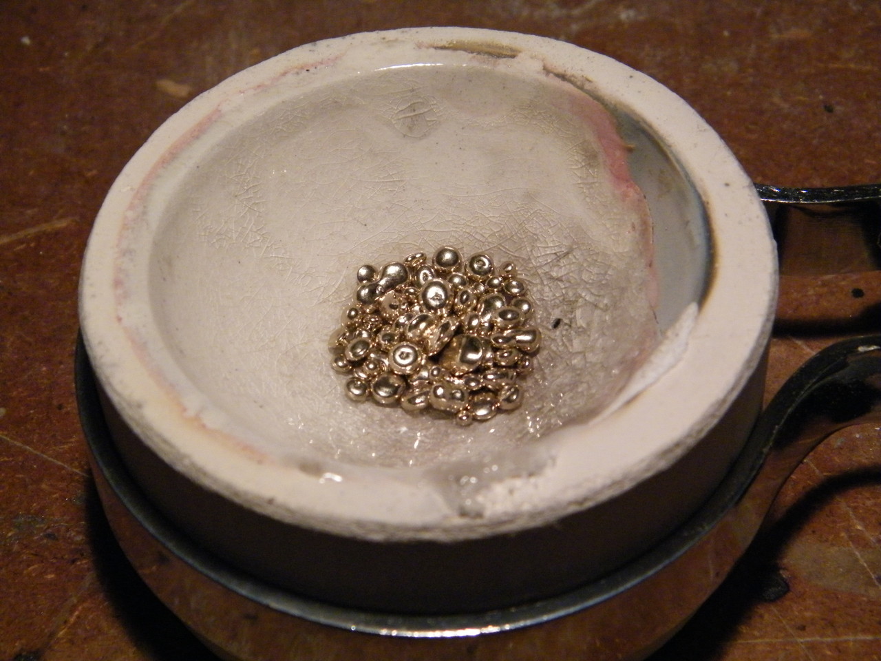 Meanwhile, the casting grain is ready for melting.  Here we have 14K white gold in the crucible.