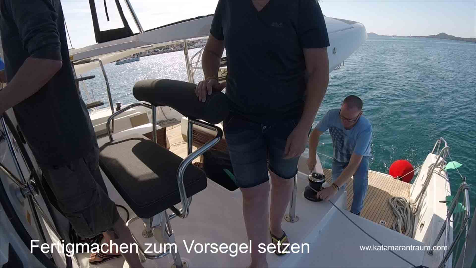 The catamaran training participants set the foresail